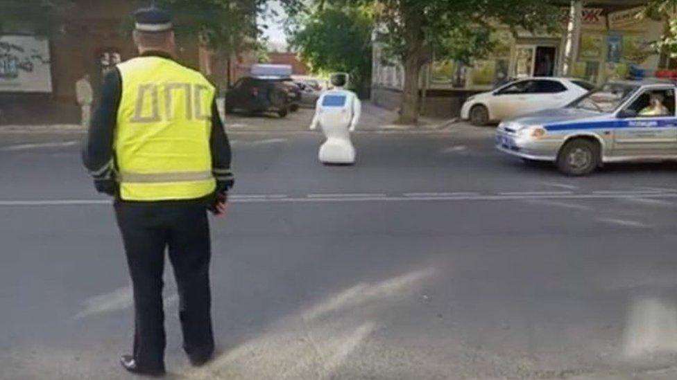 Robot standing in traffic