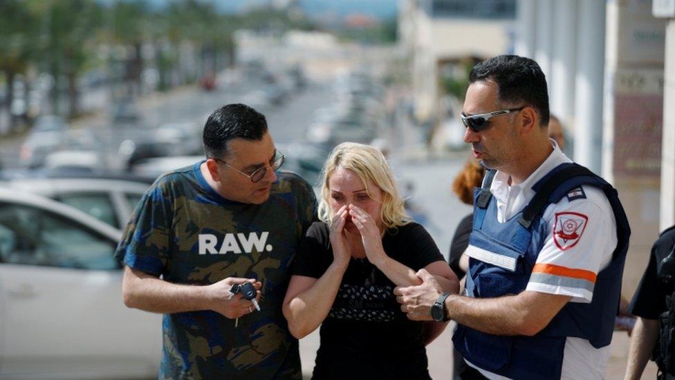 Woman comforted after rocket attack in Ashkelon