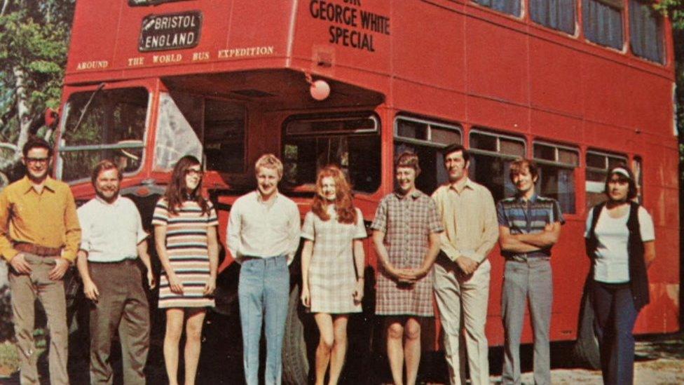 Group next to double-decker bus