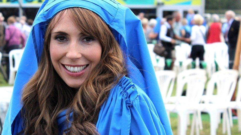 Alex Jones in her blue robes