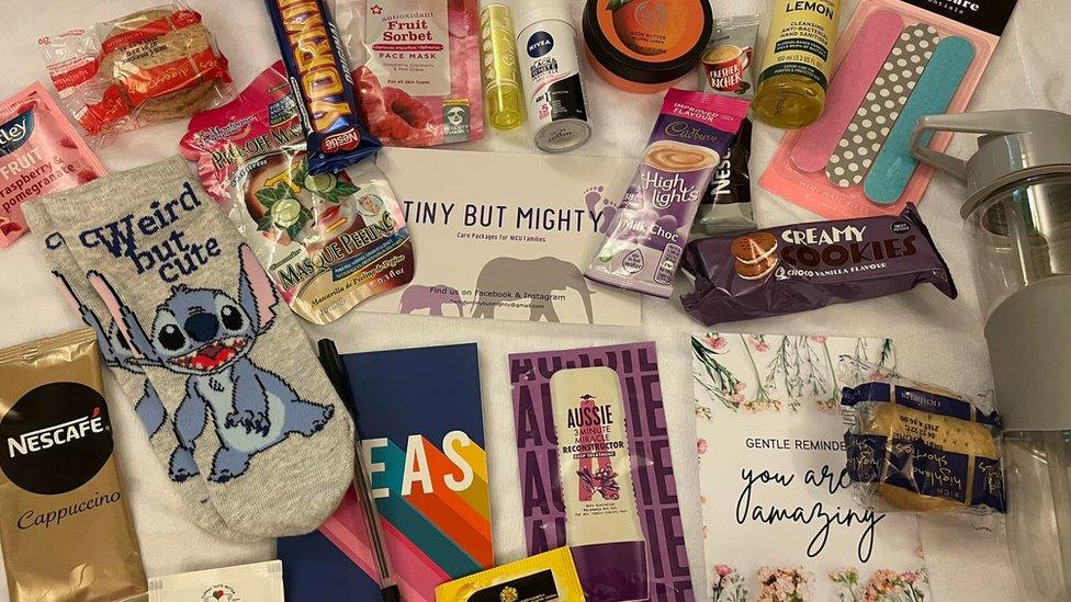 A care pack including face mask, cookies, nail file, deodorant, tea and a reusable water bottle