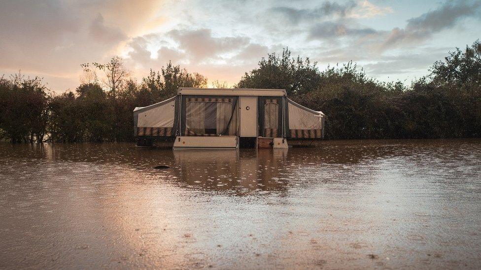 Caravan surrounded by water