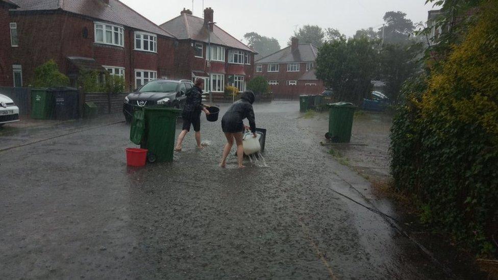 People clearing drains in Loughborough