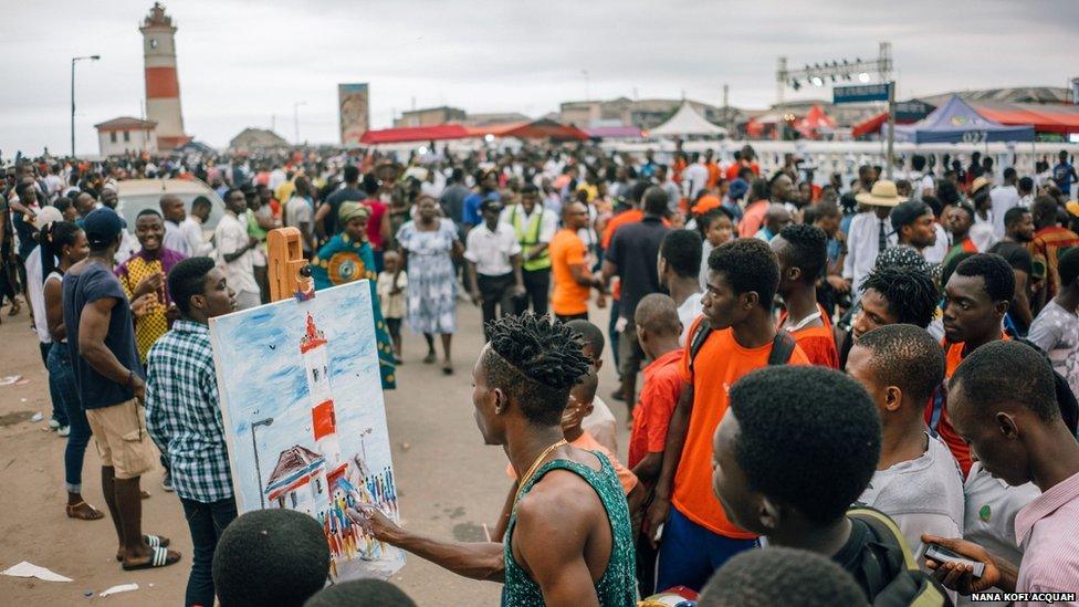 Deff Art, hand paints the lighthouse tower live as people watch on. Chale Wote Street Art Festival, Accra 2015