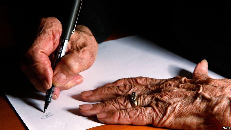 Elderly woman writing document