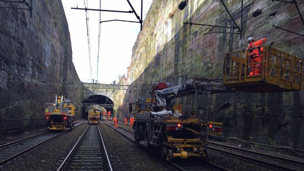 Workers repair the overhead lines near Lime Street