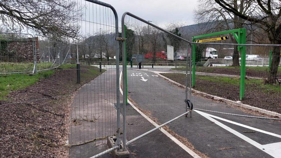 construction fence in front of a car park