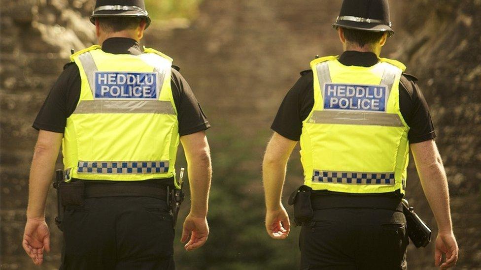 Two police officers walking away