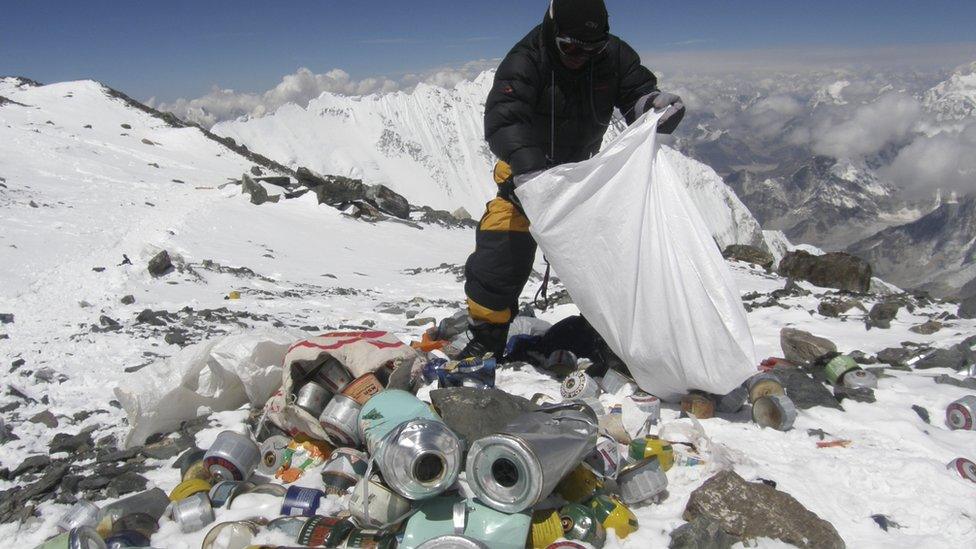 This picture taken on 23 May 2010 shows a Nepalese sherpa collecting garbage, left by climbers, at an altitude of 8,000 metres during the Everest clean-up expedition at Mount Everest.