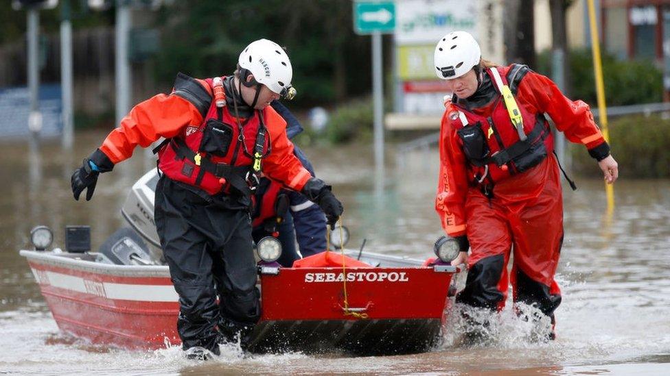 rescue crews drag a boat in the water