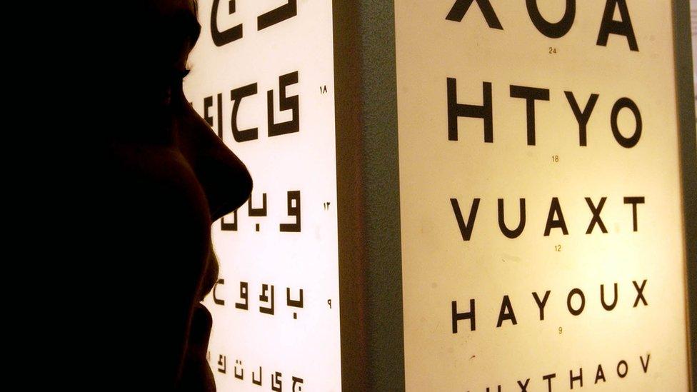 a nurse supervising an eye test at the diabetes clinic