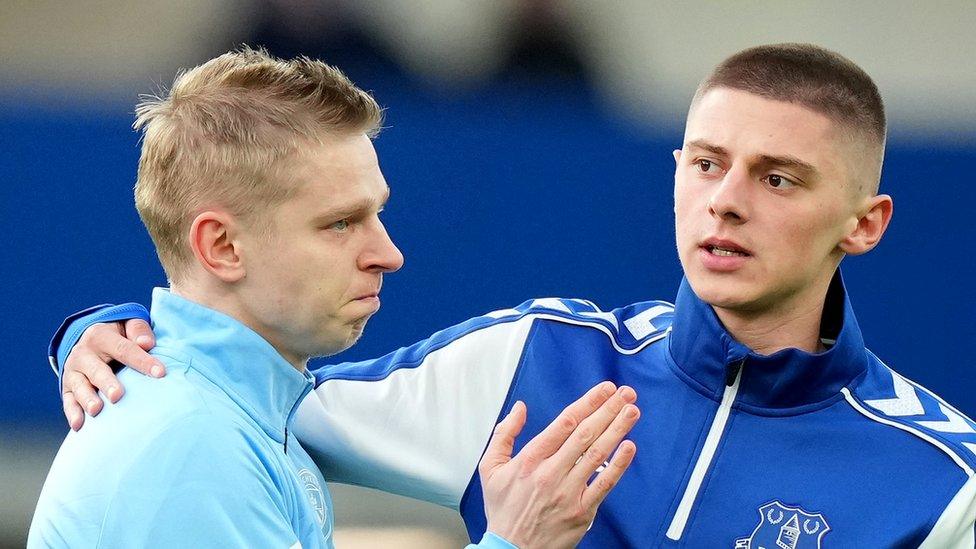 Oleksandr Zinchenko of Manchester City embraces fellow countryman Vitaliy Mykolenko of Everton