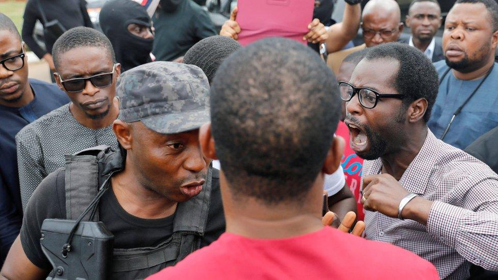 Man shouting at one of the armed security men