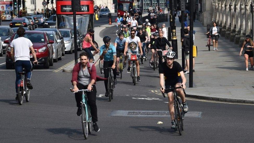 People cycling through London