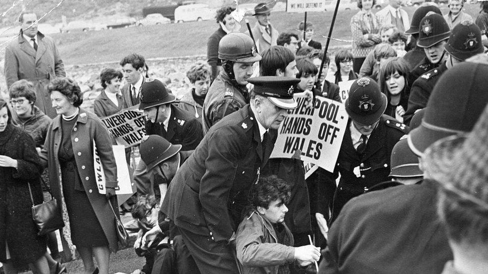 Welsh nationalist demonstrators pictured at the opening of Tryweryn reservoir are confronted by police on 21 October 1965