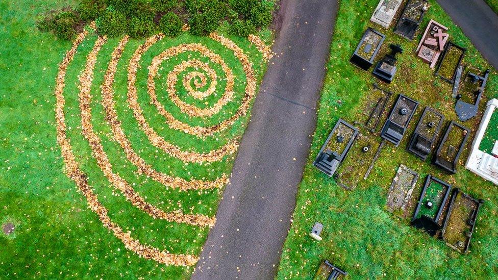 An aerial shot of a land sculpture made from leaves