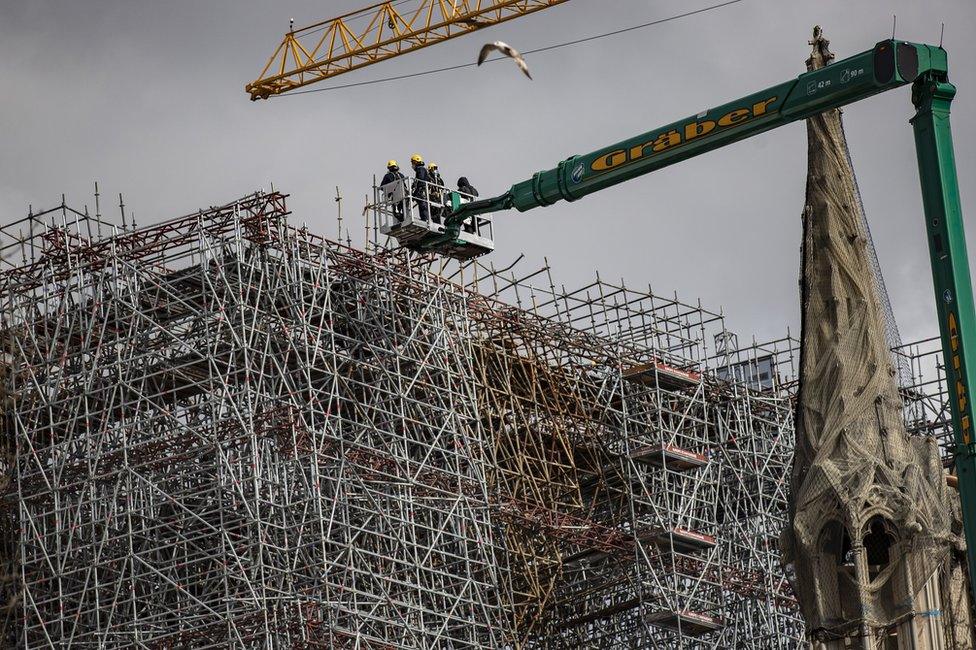 Workers are seen restoring the Notre-Dame cathedral