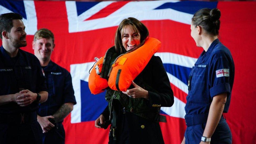 The Princes of Wales tries on a life jacket while on a visit to the Royal Naval Air Station Yeovilton in Somerset