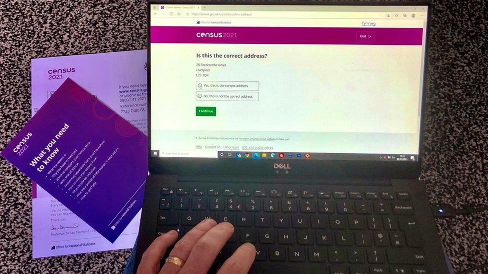 computer with the census on and paper census next to it