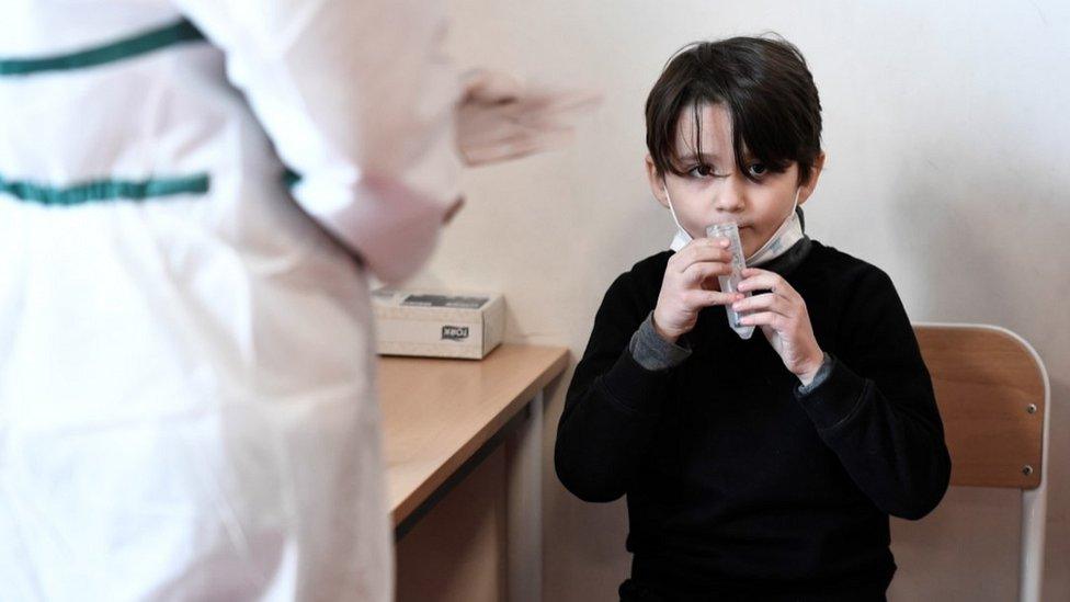 French boy giving saliva sample for Covid test, 11 Feb 21