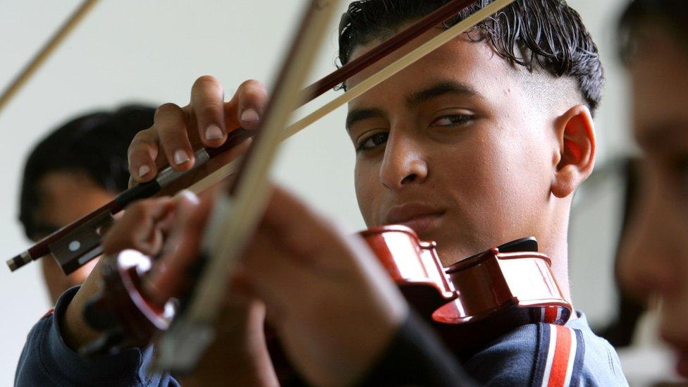 A boy plays the violin