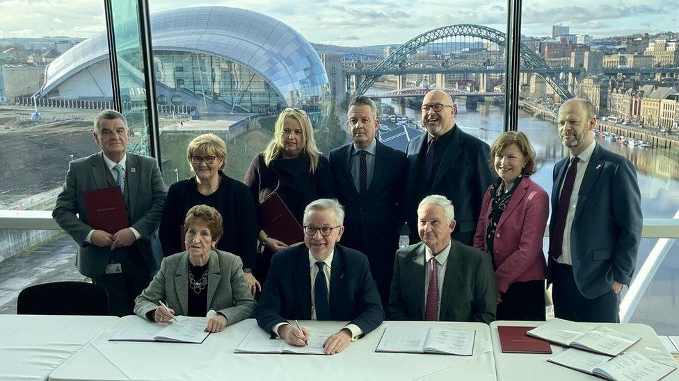 Levelling up secretary Michael Gove signs the North East devolution deal with local council leaders at the Baltic art gallery in Gateshead