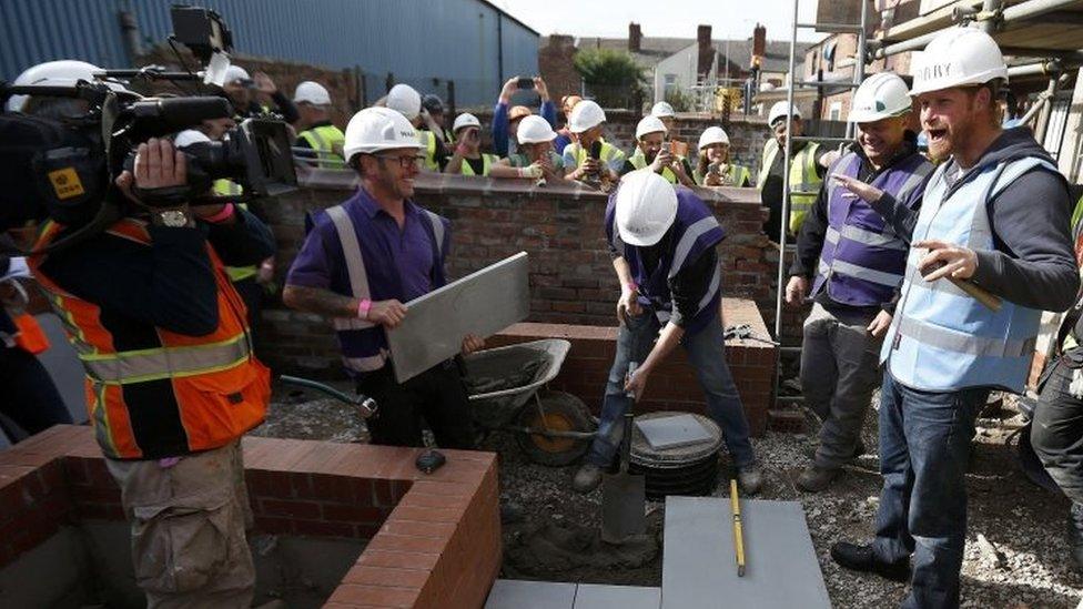 Prince Harry laying paving for DIY SOS