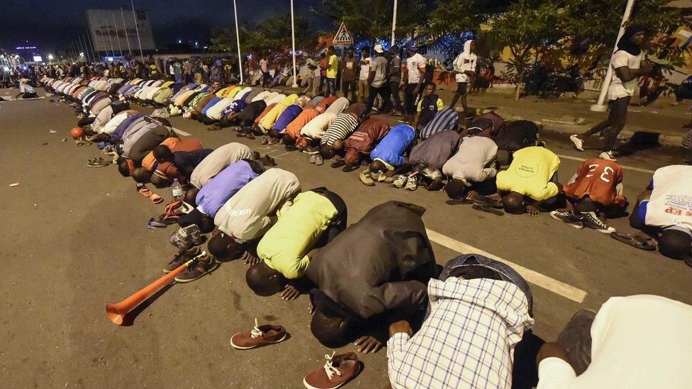 Opposition supporters praying during previous protests