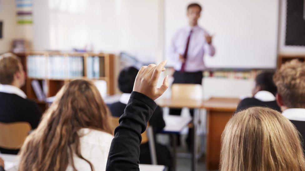 Student Raising Hand To Ask Question