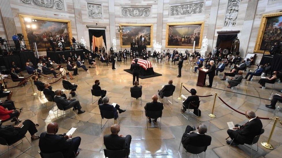 People pay their respects to the flag-draped casket of the late Rep. John Lewis