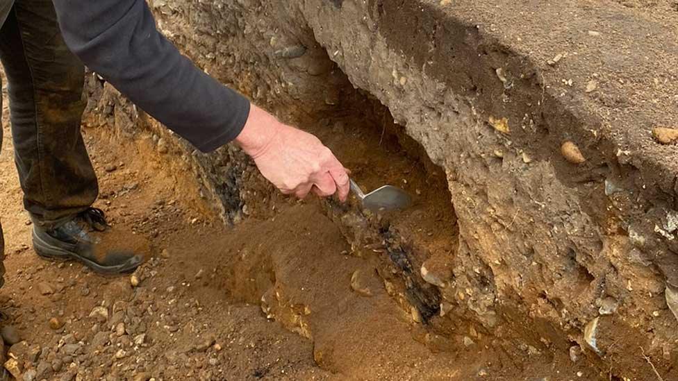 Archaeologist at Arminghall Henge