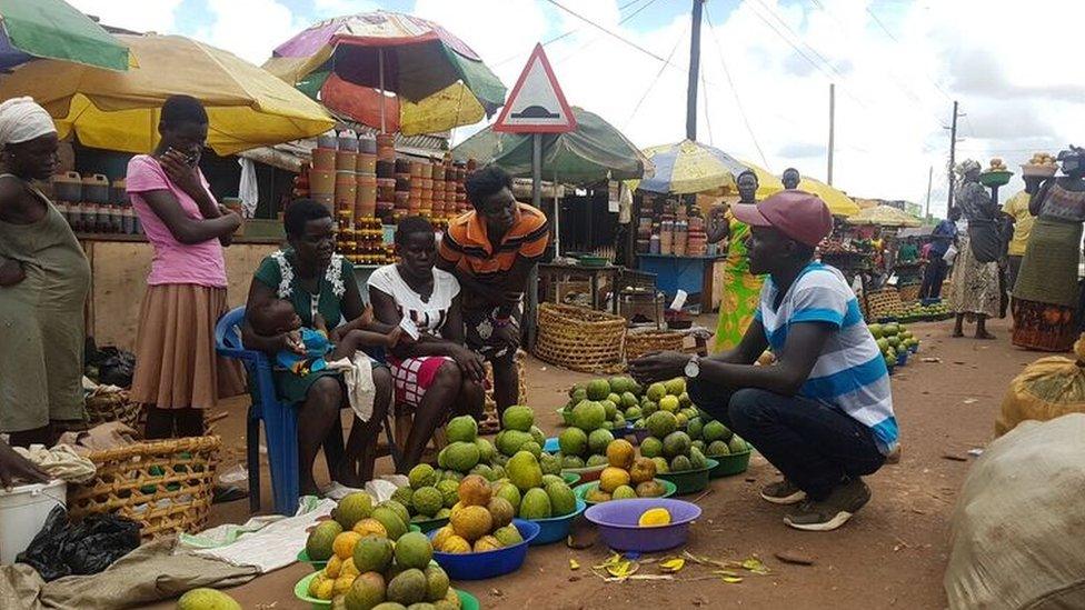 Lawrence talking to market traders