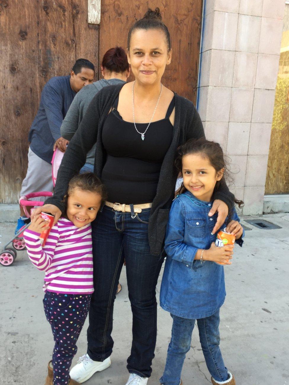 A woman and two children pose for a photo near the US-Mexico border, 29 April 2018