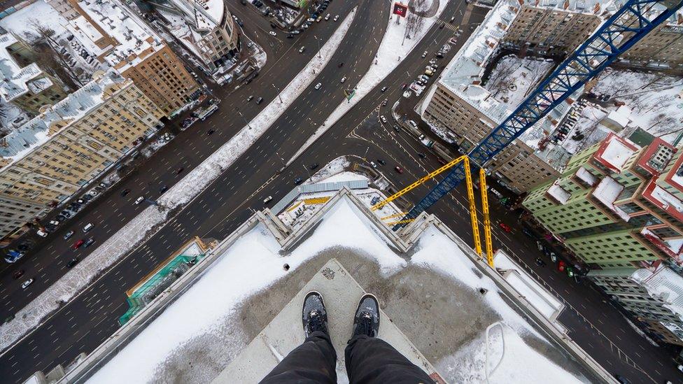 Kirill Vselensky standing on the corner of a high building