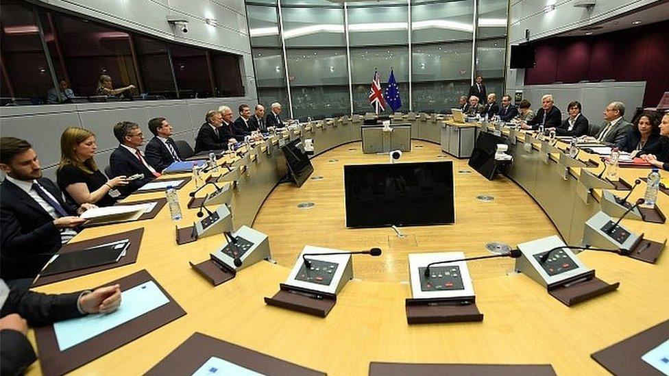 British and EU officials on the first day of Brexit talks last month