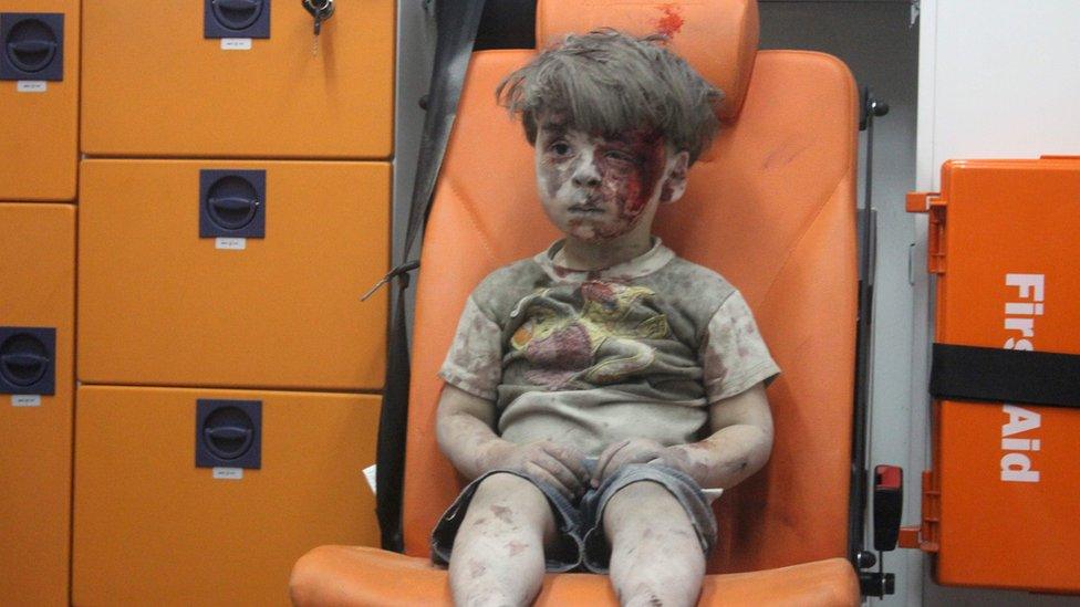 Omran Daqneesh, a four-year-old Syrian boy covered in dust and blood, sits in an ambulance after being rescued from the rubble of a building hit by an air strike in the rebel-held Qaterji neighbourhood of the northern Syrian city of Aleppo late on August 17, 2016.