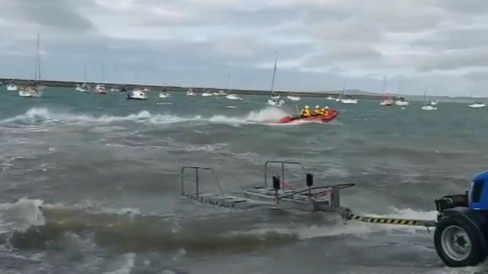 A three-man lifeboat crew were in the water within eight minutes