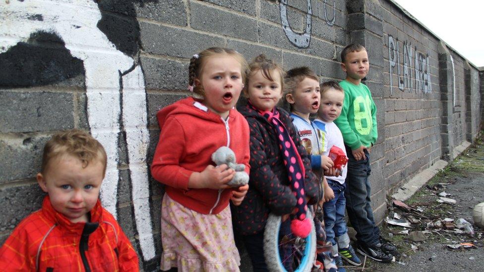 Children stand next to a wall in St Mary's