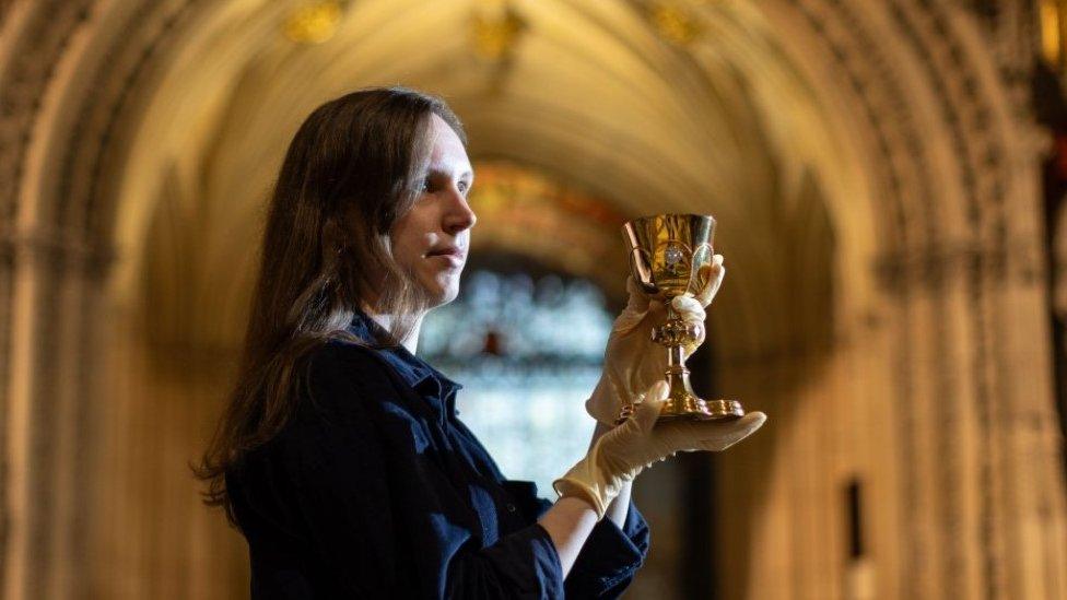 Kirsty Mitchell, from the Minster's collections team, poses with a Forepaugh chalice and paten