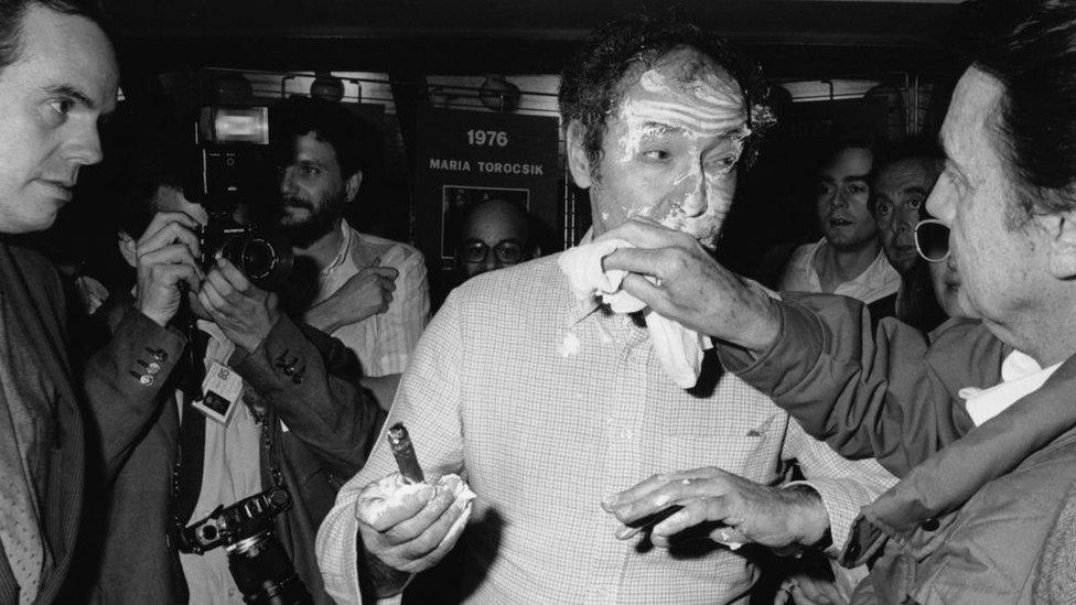 Jean-Luc Godard receives a pie to the face