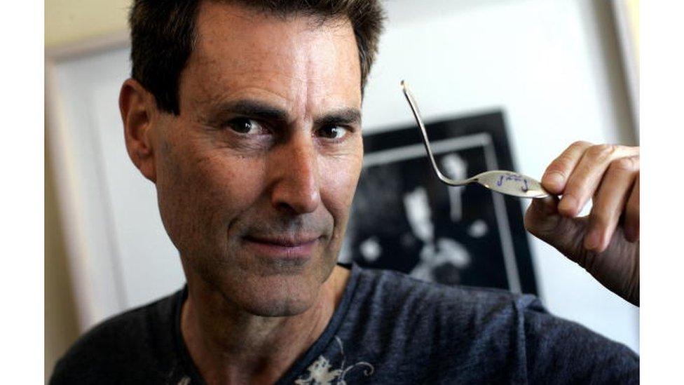 Uri Geller with a bent spoon