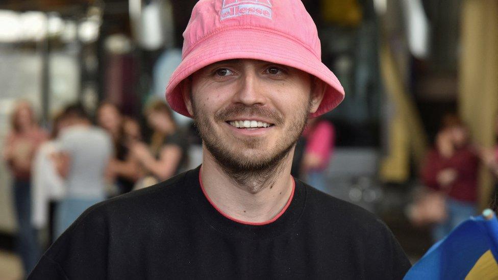 Oleh Psiuk, frontman of the 2022 Eurovision Song Contest winners Kalush Orchestra, smiles as he arrives at the Ukraine-Poland border crossing point near the village of Krakovets, in Lviv region, Ukraine May 16, 2022