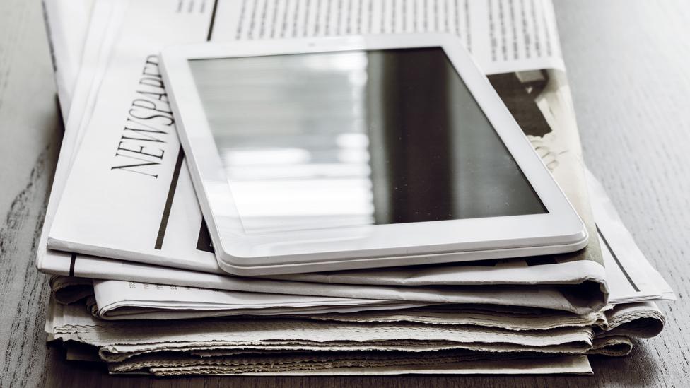 Newspapers and an tablet