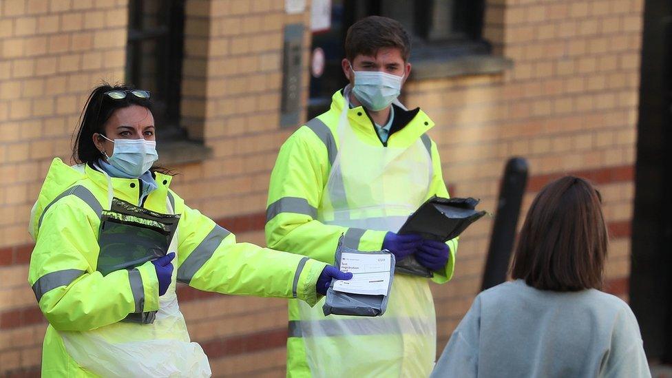 NHS staff hand out test kits to Glasgow University students