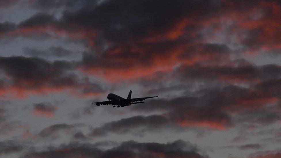 A plane approaching Heathrow at dawn