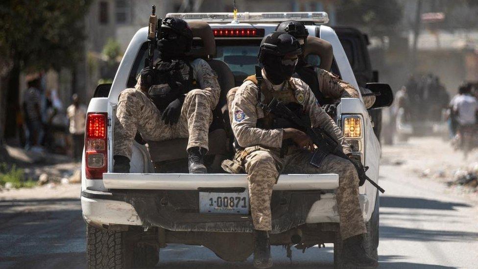 Armed Haitian National Police officers escort the convoy of the three officers killed by armed gangs after the funeral ceremony at the National Police Academy, in Port-au-Prince, Haiti January 31,2023.