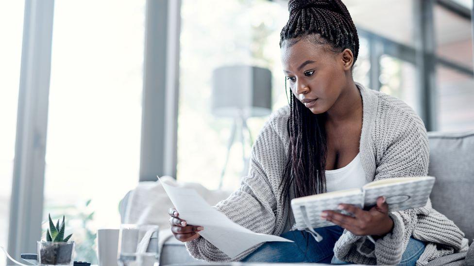 Woman looking at bills at home