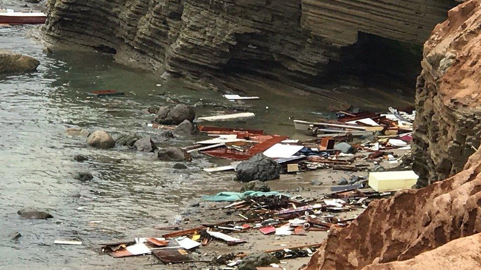 Debris from the boat washes up on to the beach