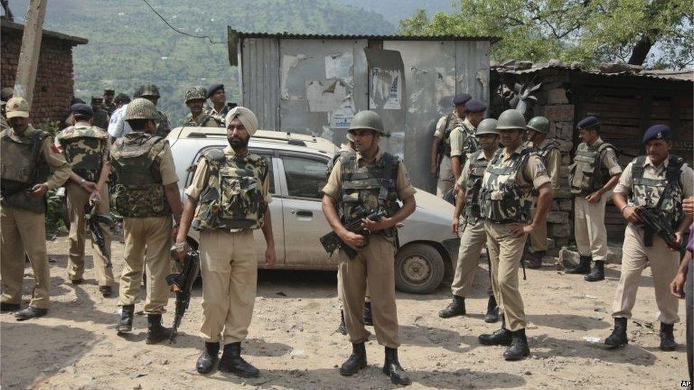 Indian paramilitary soldiers stand after a gunbattle on the Jammu- Srinagar highway at Narsoo Nallah, near Udhampur, India, Wednesday, Aug. 5, 2015