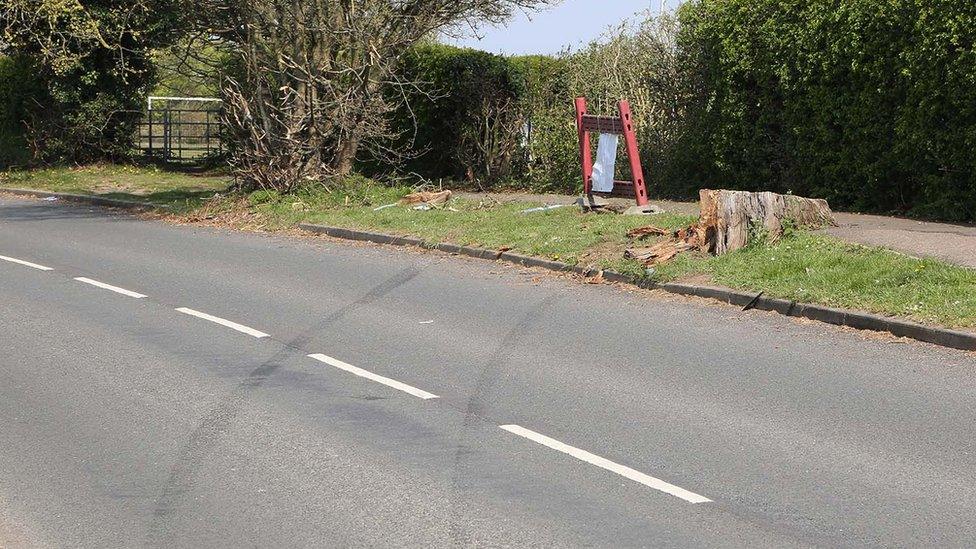 Marks in road by cemetery